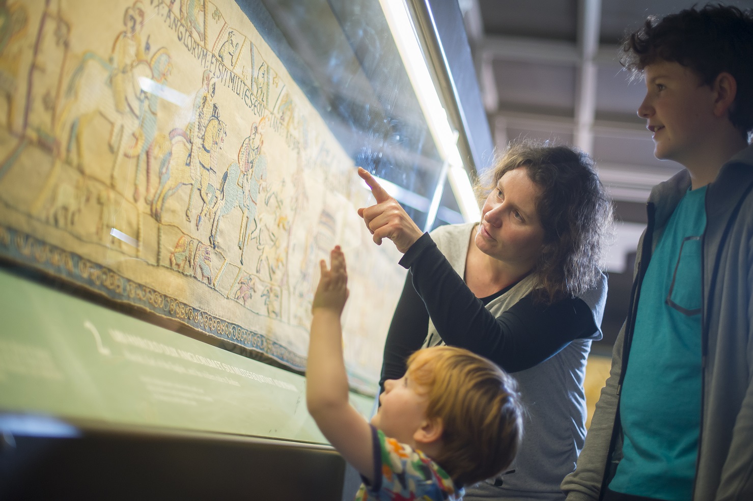 Family looking at Bayeux Tapestry in Reading Museum